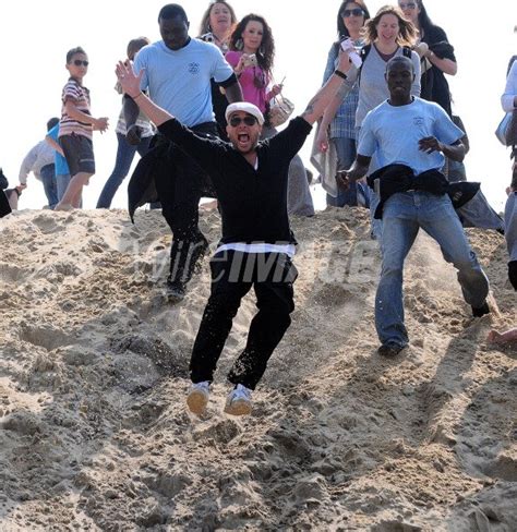 French singer Pascal Obispo runs down a dune after the gathering for ...