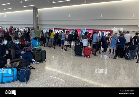 People wait in line at the Avis counter at the Salt Lake City ...
