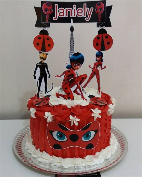 A Red Cake With Ladybugs On It Sitting On A Plate