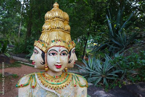 Religious sculpture four-headed God Brahma. Stock Photo | Adobe Stock