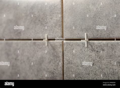 Stylish Tiles With Spacers On Wall In Room Stock Photo Alamy