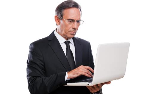 Businessman At Work Confident Mature Man In Formalwear Working On Laptop While Standing