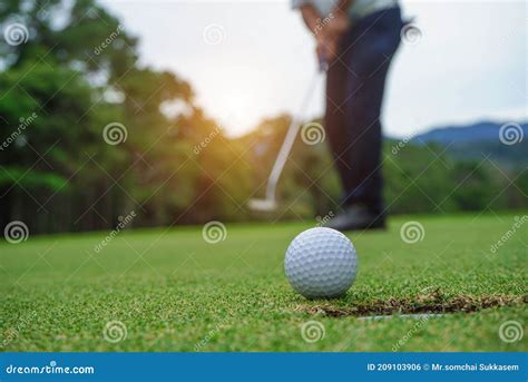 Blurred Golfer Playing Golf In The Evening Golf Course On Sun Set