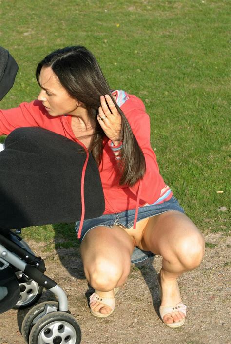 Squatting In A Short Skirt In A Park And Showing Her Pussy