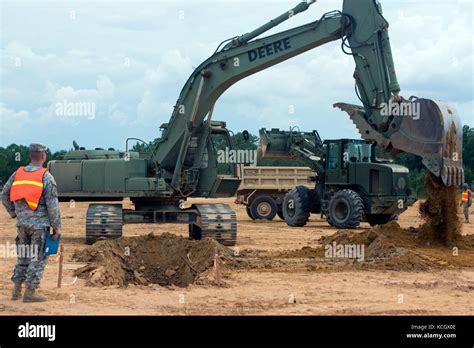 Us Army Sgt Jim Miller Operates A Heavy Equipment Excavator To Dig A