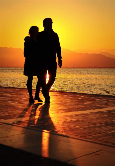 Download Couple At Beach Sunset Silhouette Wallpaper