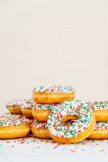 Free Photo | Donuts with white chocolate cream and sprinkles sugar