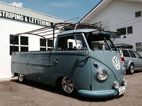 An Old Vw Bus Parked In Front Of A Building