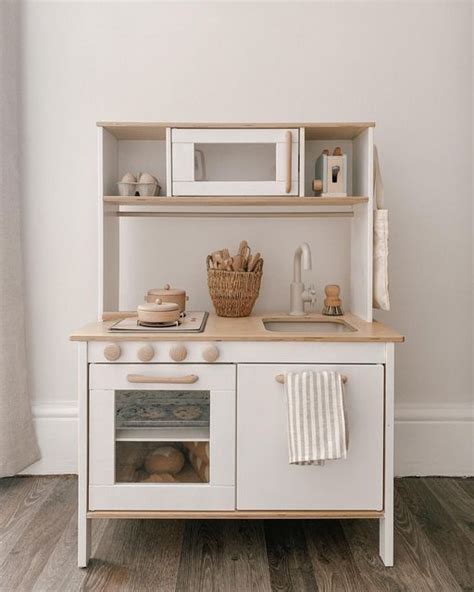 A White Play Kitchen With An Oven Sink And Microwave