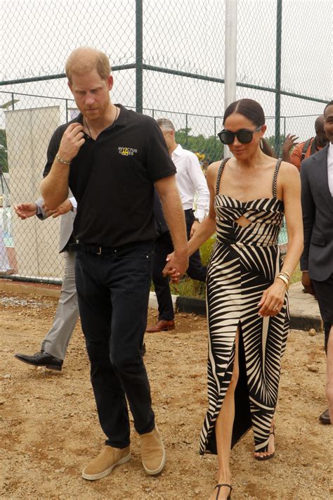 Meghan Markle Pairs Zebra Print Dress With Trendy Thong Sandals At The