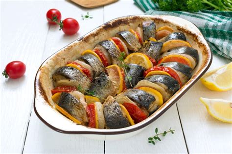 Baked Fish With Vegetables Pieces Of Herring Onion Tomato Lemon