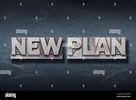 New Plan Phrase Made From Metallic Letterpress On Dark Jeans Background