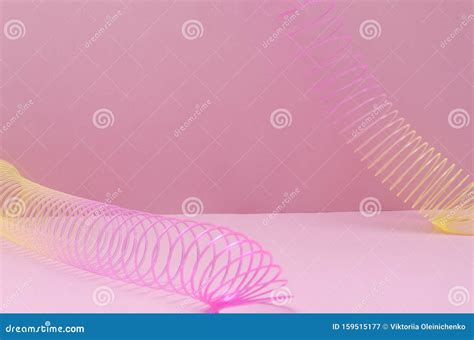 Colored Slinky Toy On The Pink Surface Editorial Photography Image Of Abstract Rainbow 159515177