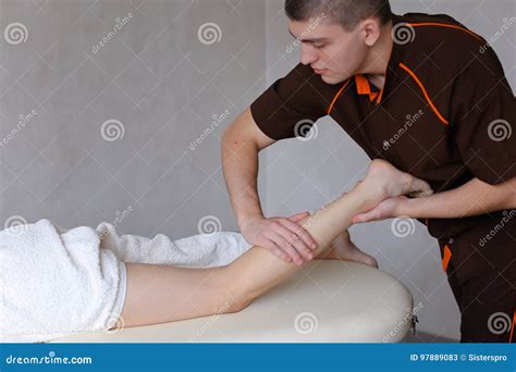 Handsome Male Massage Therapist Performs Procedure For Girl S Le Stock