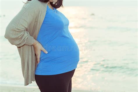 Pregnant Woman Holding Her Belly On The Beach With Copy Space In Stock Image Image Of Body