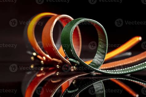 A Group Of Multi Colored Leather Belts On A Black Background 20129012