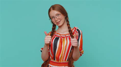 Redheaded Girl Raises Thumbs Up Agrees Or Gives Positive Reply