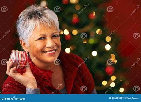 I Wonder Whats Inside A Mature Woman Holding A Christmas Present To