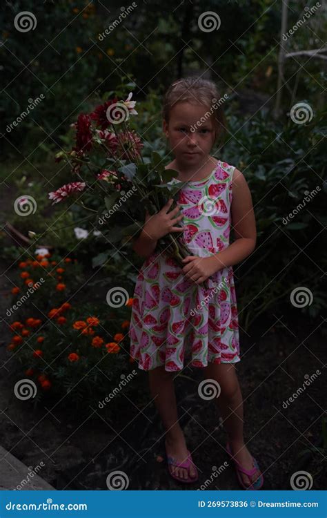 Portrait Of A Woman With Lots Of Freshly Picked Up Colorful Dahlias And