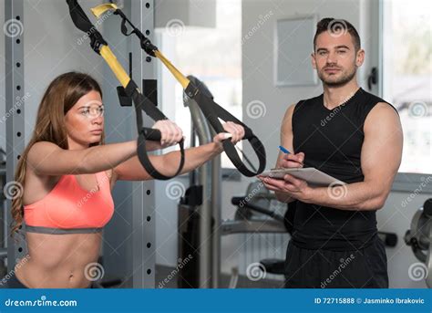 Trainer With Clipboard Woman On Trx Fitness Straps Stock Photo Image