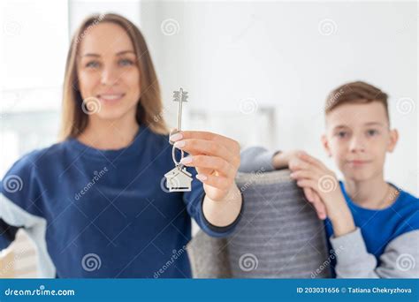 Blurry Good Looking Mom And Son Are Holding The Keys To A New Apartment