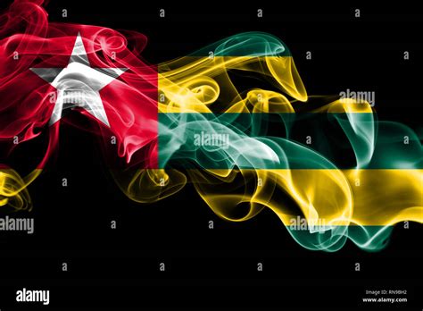 National Flag Of Togo Made From Colored Smoke Isolated On Black Background Abstract Silky Wave