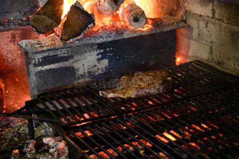 Large Beef Steak Grilled On Olive Wood Firewood Grill In Small Village