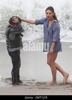 Mila Kunis Runs In Her Bikini And A Short Blue Shirt While Filming A Scene For Friends With