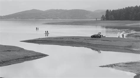 People on Lake and Lakeshore in Black and White · Free Stock Photo