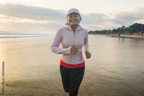 Fit And Attractive Mature Woman With Grey Hair Doing Beach Workout On Her S Running On The