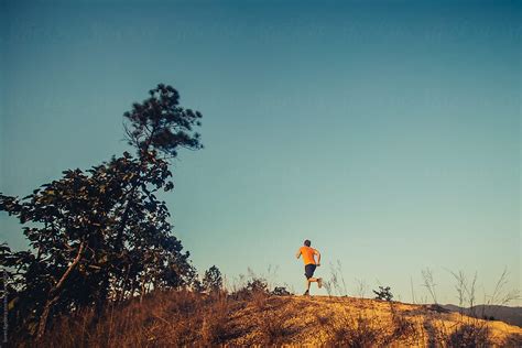 Man Jogging Outdoors At Sunset by Soren Egeberg