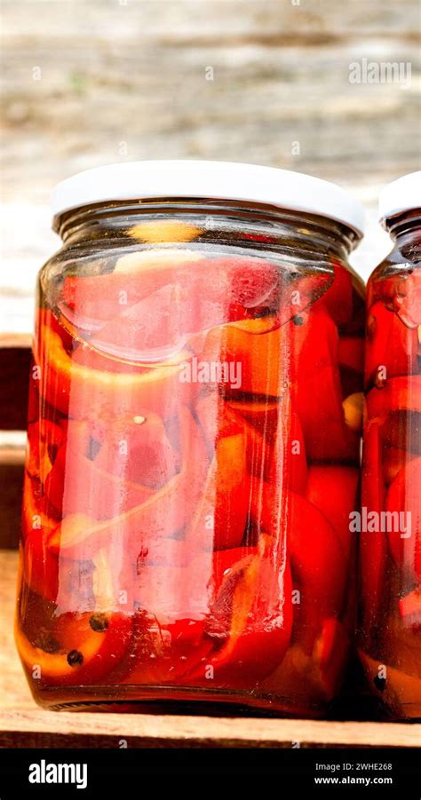 Wooden Crate With Glass Jars With Pickled Red Bell Peppers Preserved