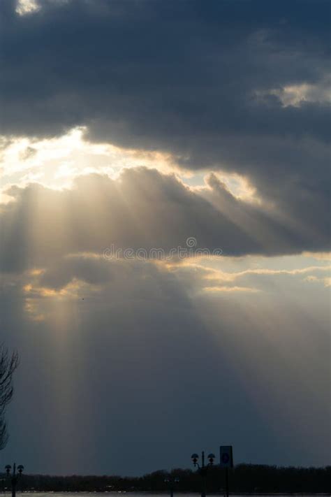 The Sun S Rays Break Through The Dark Clouds Stock Photo Image Of