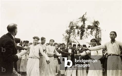 Image of Dancing at an Arab wedding, Palestine. Several men perform a