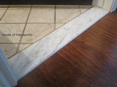 Install marble thresholds leading into bathrooms