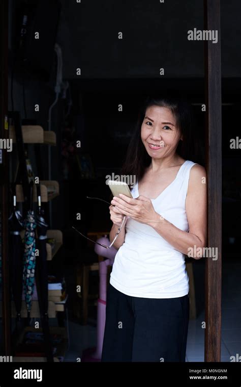 Senior Brunette Business Woman Smiling At Camera And Working With Her Phone Stock Photo Alamy