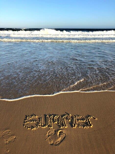 Premium Photo Text On Sand At Beach Against Sky