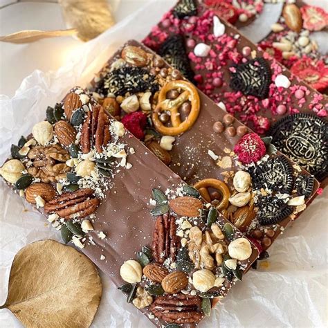 Two Pieces Of Chocolate With Nuts And Pretzels On Top