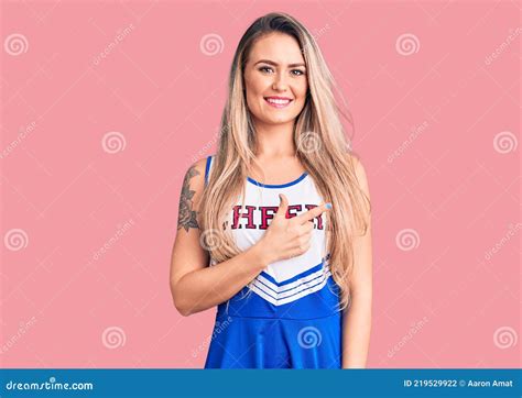 Young Beautiful Blonde Woman Wearing Cheerleader Uniform Cheerful With