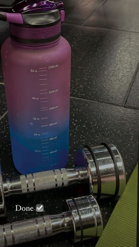 A Purple And Blue Water Bottle Sitting On Top Of A Table Next To Metal