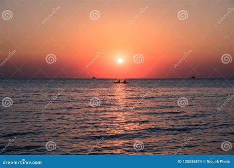 Rowing boat at sunset stock photo. Image of clouds, beautiful - 125536874