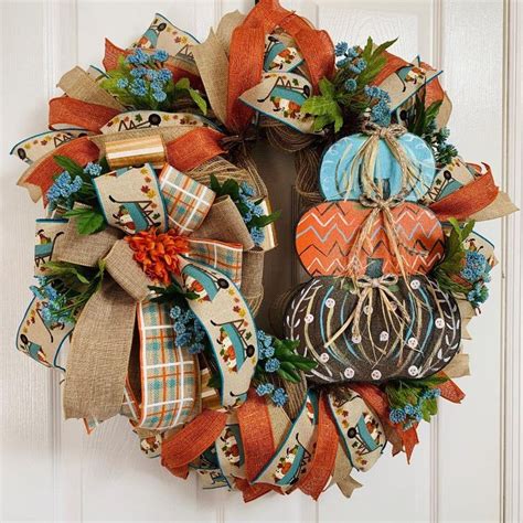 A Wreath With Pumpkins And Fall Leaves On It