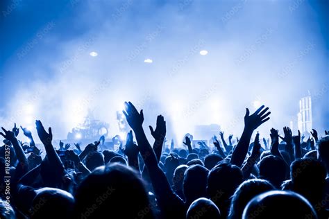 silhouettes of concert crowd in front of bright stage lights Stock ...