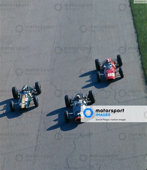 Race Winner Jackie Stewart GBR BRM P261 Leads Jim Clark GBR Lotus