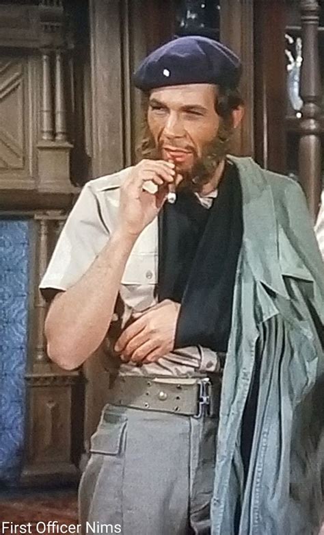 The Man Is Brushing His Teeth While Standing In Front Of Another Man