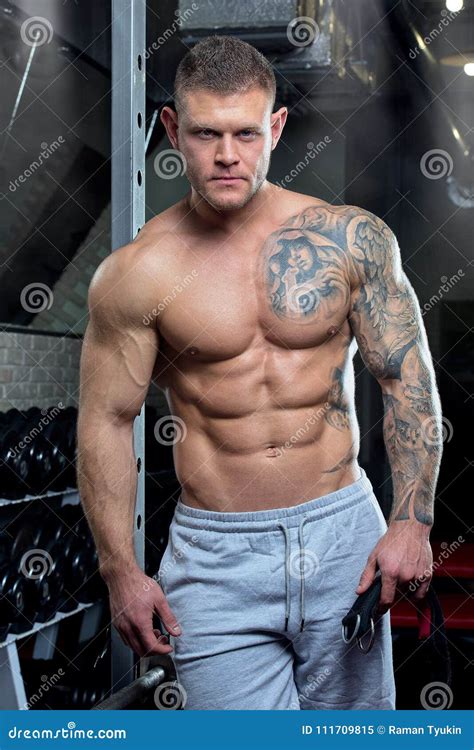 Muscular Shirtless Shredded Strong Relaxed Man With Blue Eyes And