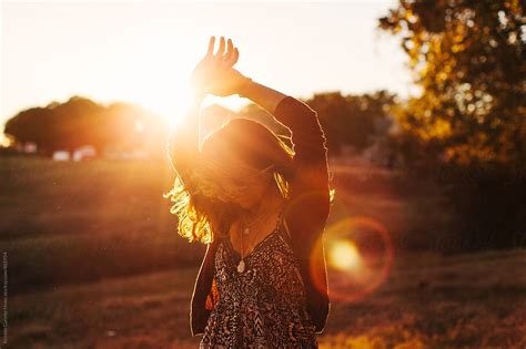 "A Young African American Woman Dancing In A Field While The Sun Is Setting." by Stocksy ...