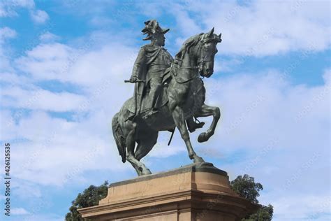 A bronze statue of King Edward VII in uniform on horseback. The statue is on a sandstone plinth ...