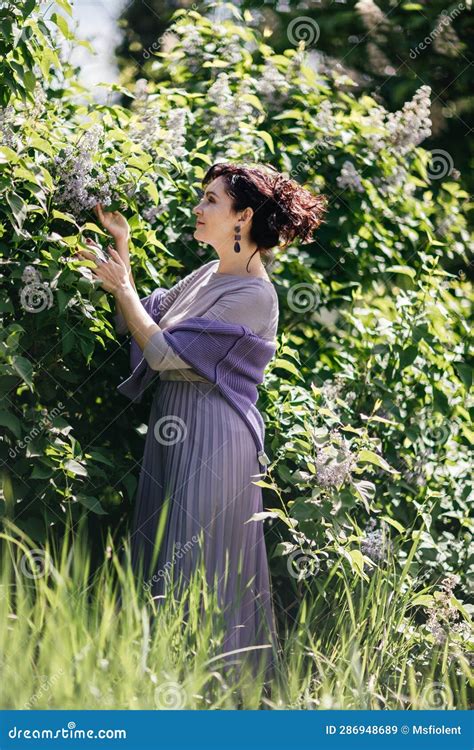 Woman Lilac Portrait Of An Happy Woman Surrounded By Lilac Bushes