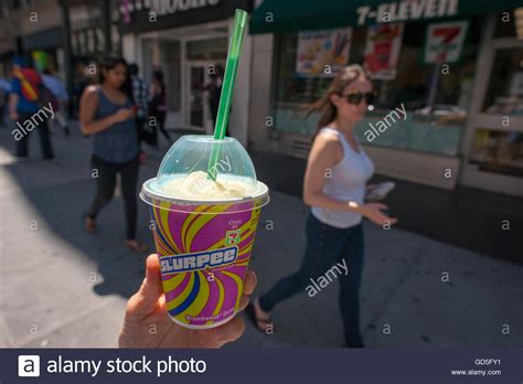 A Slurpee Lover Displays Her Free Drink Outside A 7 Eleven Store In New